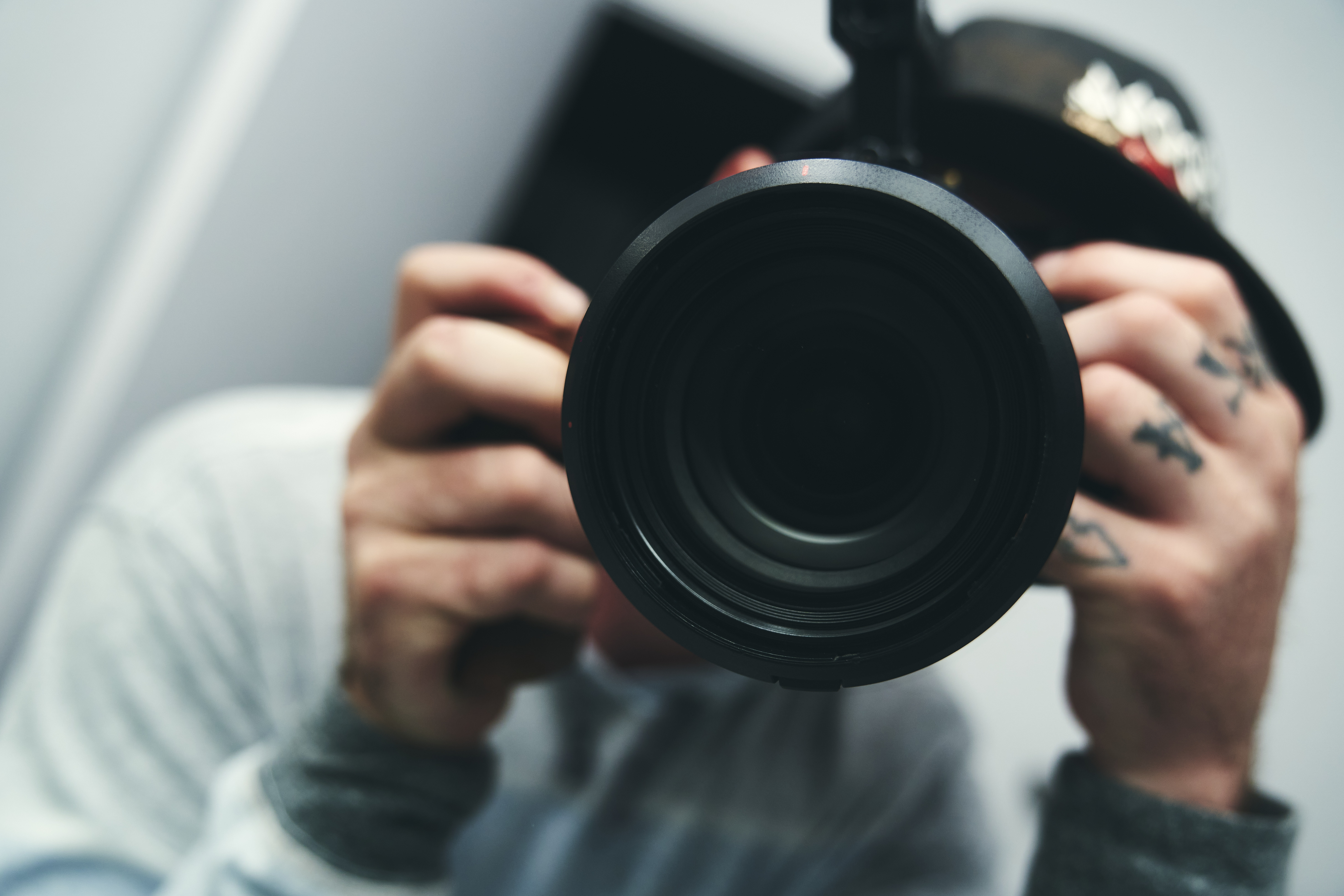 Morgan Ryan holding a camera, photographed behind the lens